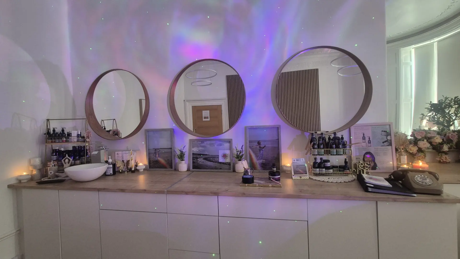 The GC Therapies treatment room in Liverpool with round mirrors and soft lighting